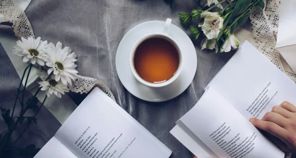 two books on a table with tea
